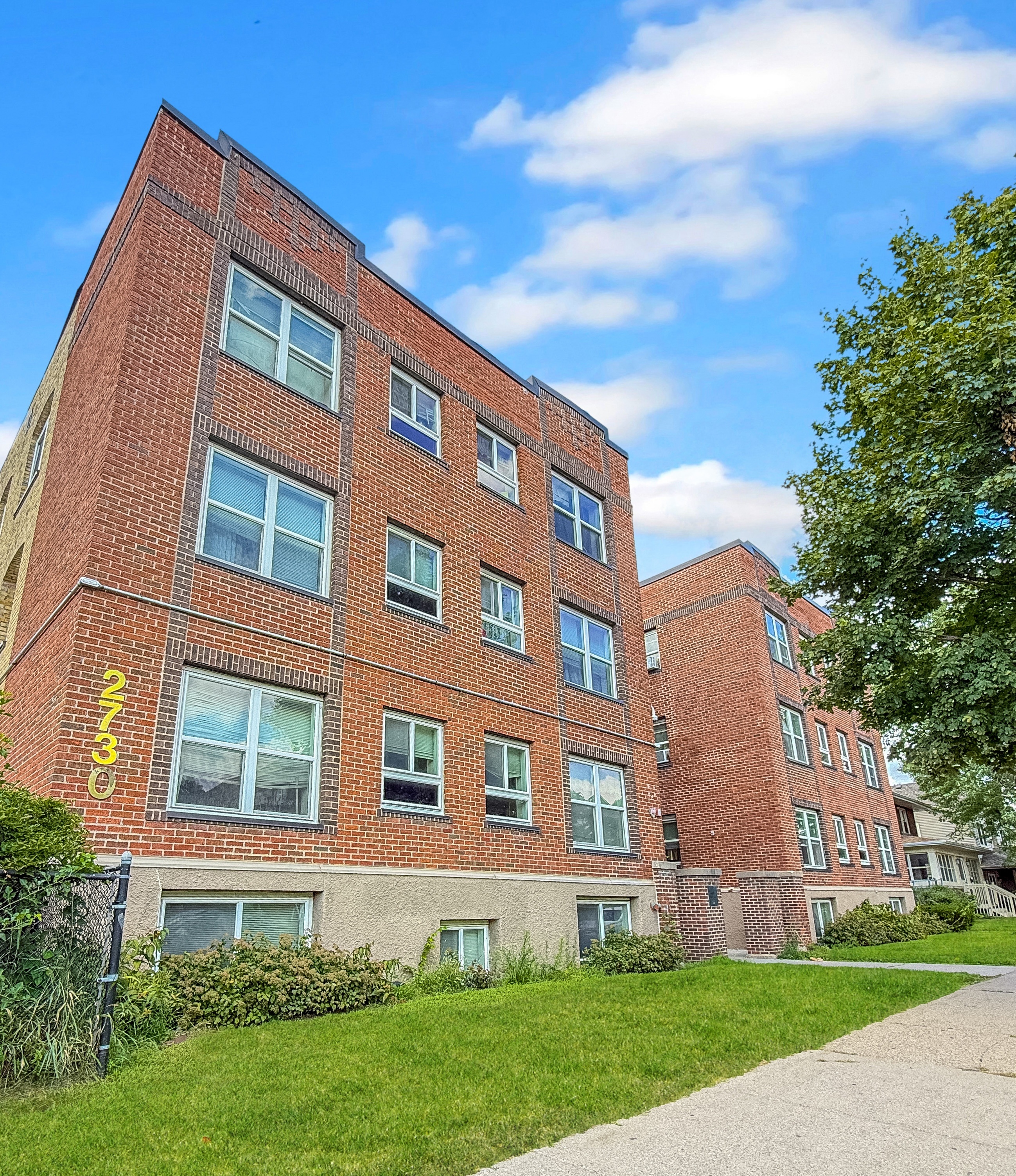 A red brick building with the number 2333 on it.